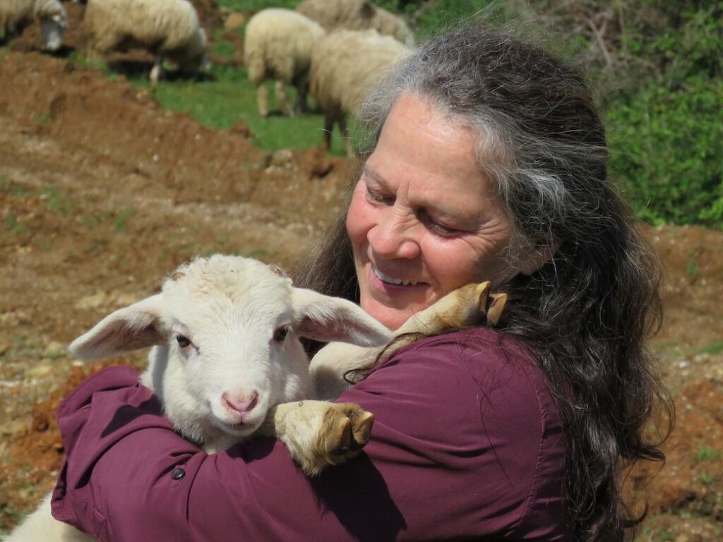 Jeanette McDermott holding a lamb while growing the vegan movement