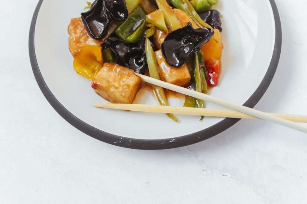 Bowl of Asian stir fry with tofu and other plant proteins