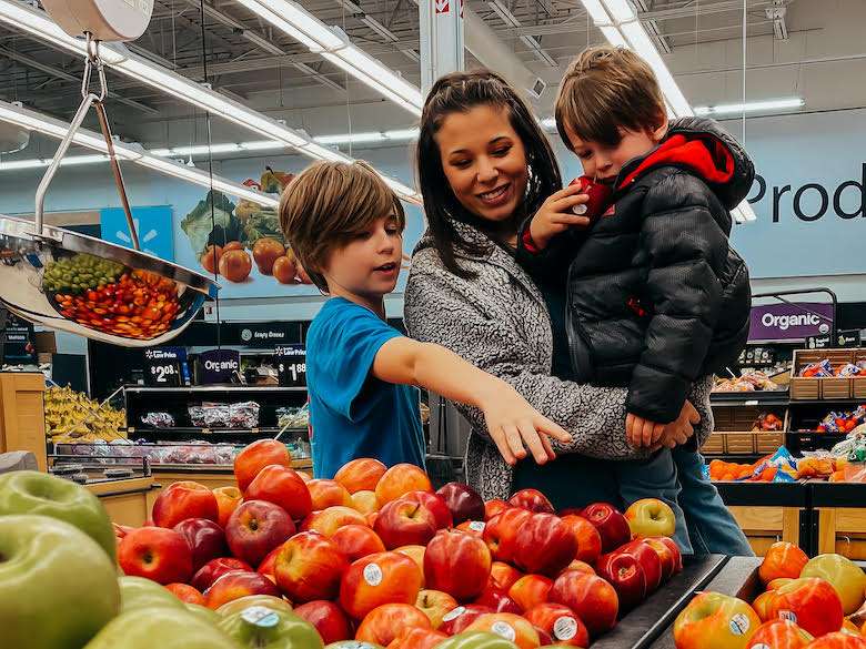 Ciara Flack picking out produce with her two young sons