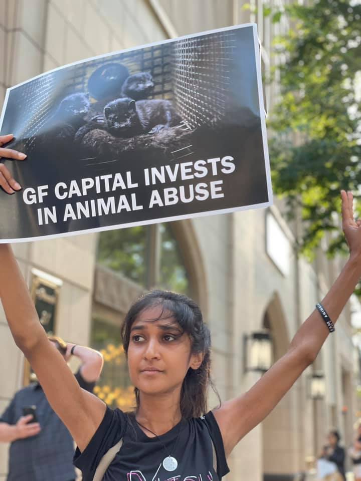 Shriya holding a protest sign while fighting for animal liberation