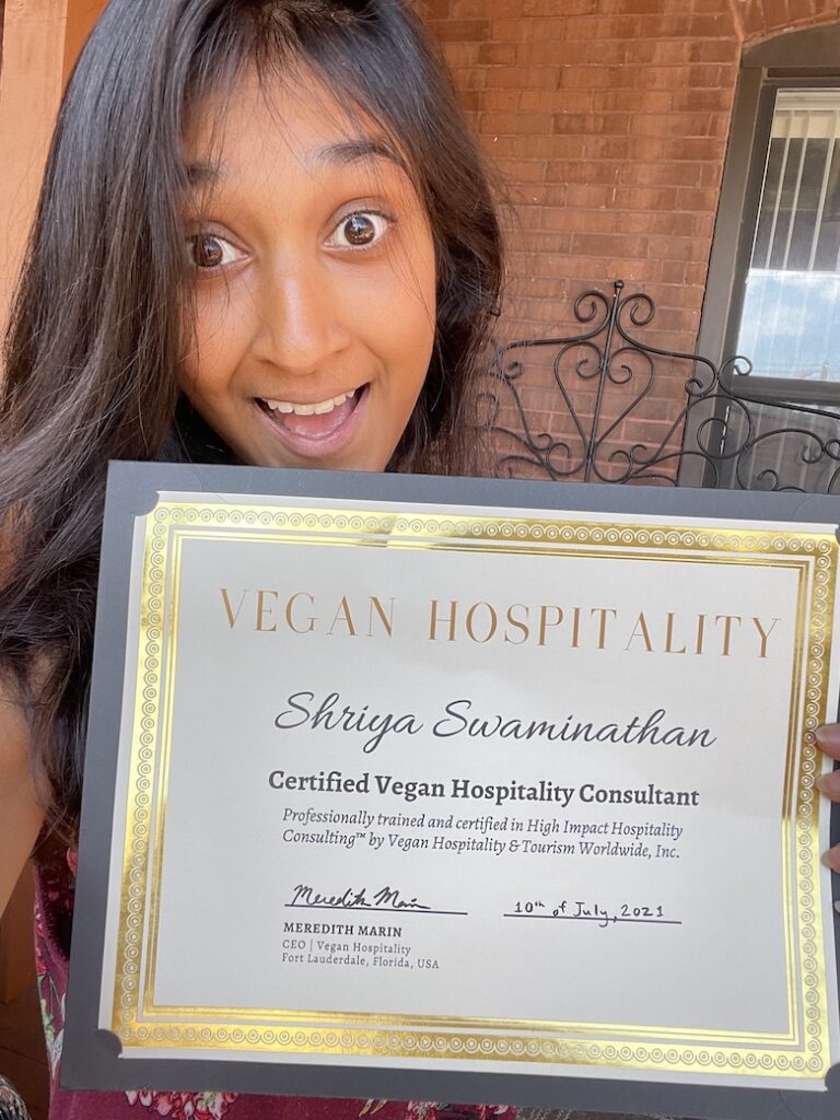 Shriya holds her certificate as a vegan hospitality consultant as part of her activism form of fighting for animal liberation