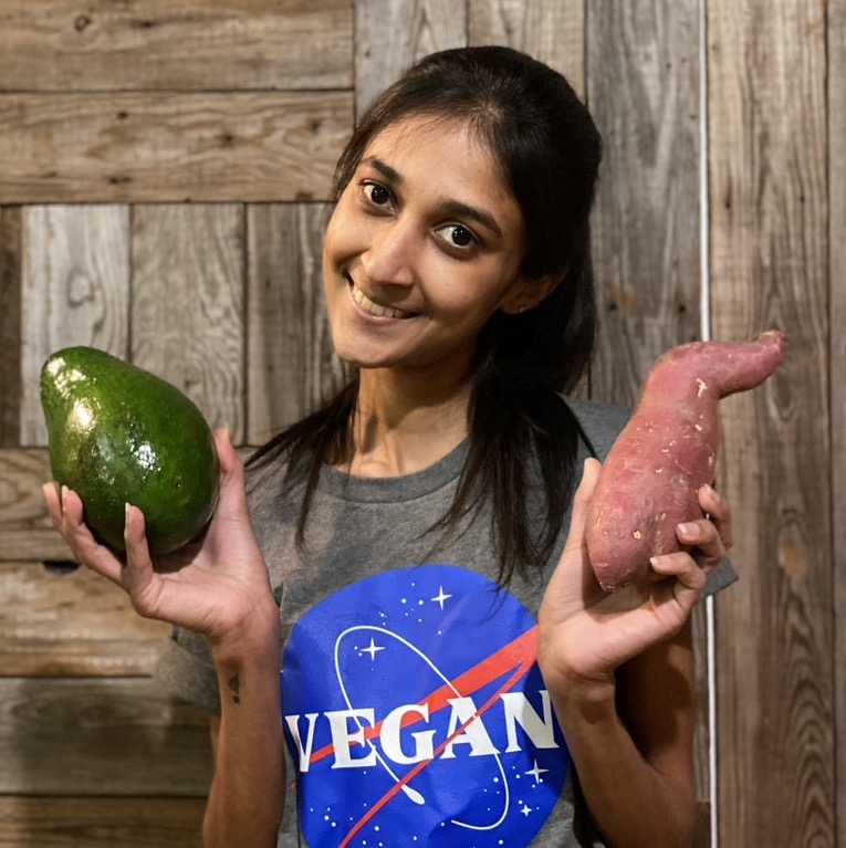 Shriya holds an avocado and sweet potato