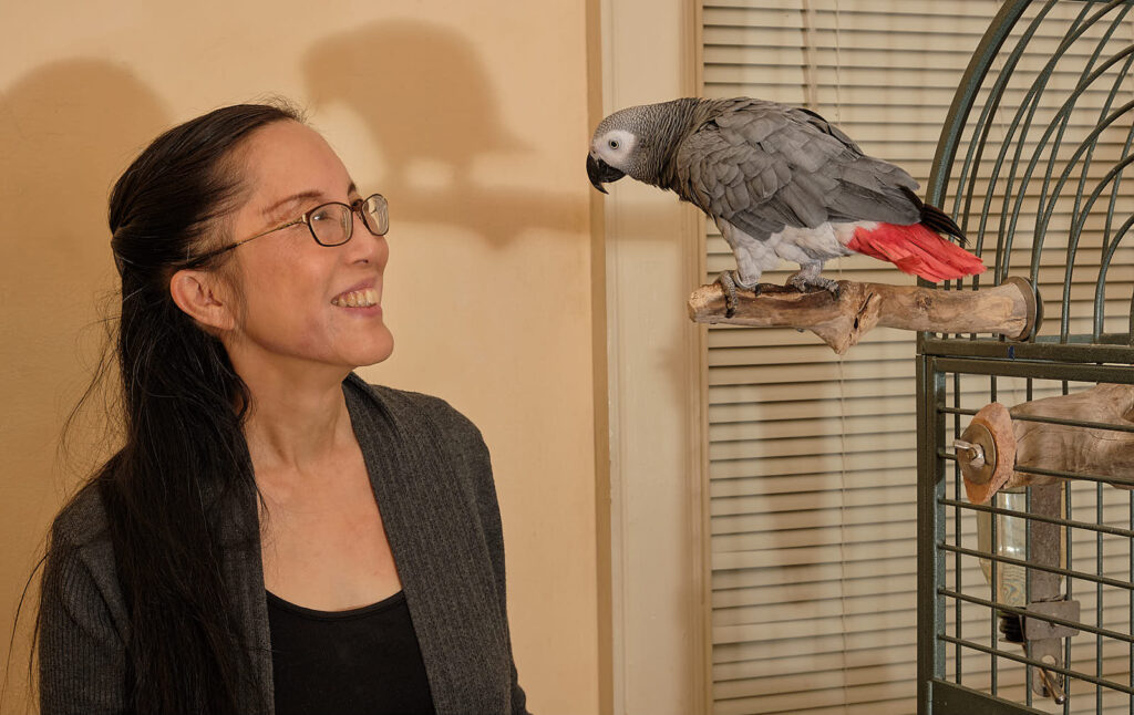 Renaissance woman Joanne Kong with her grey parrot Jerry
